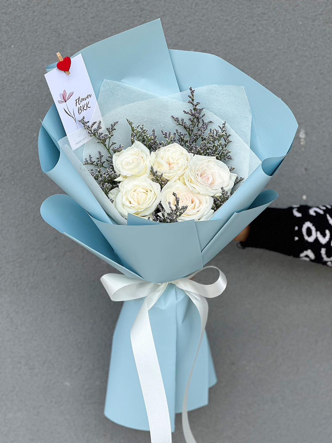 5 White Roses Wrapped in Blue Paper