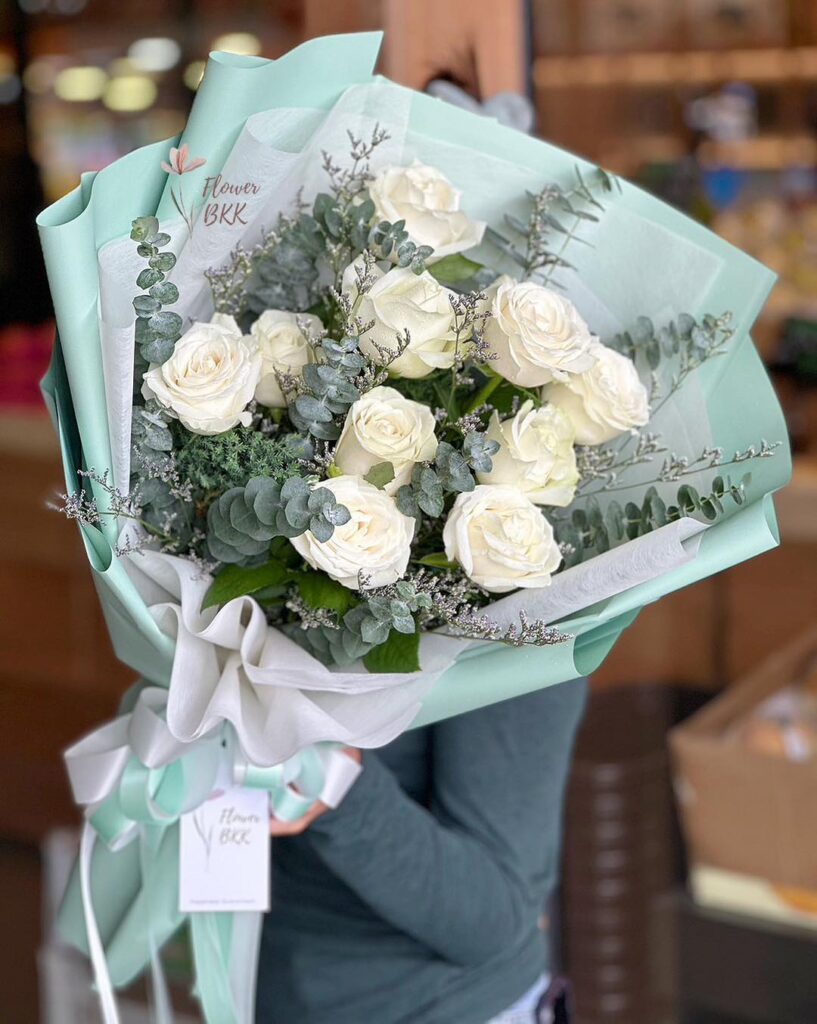Buy 10 White Roses Wrapped in Green Elegant Floral Arrangement